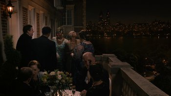 Movie still from “Bessie” (2015), directed by Dee Rees – A group of people standing on a balcony at night; Extreme Wide shot, High angle