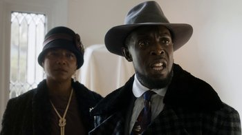 Movie still from “Bessie” (2015), directed by Dee Rees – A man and a woman wearing hats and coats; Close Up shot, Low angle