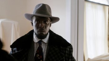 Movie still from “Bessie” (2015), directed by Dee Rees – A man wearing a hat and a jacket; Close Up shot, Low angle