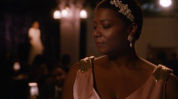 Movie still from “Bessie” (2015), directed by Dee Rees – A woman in a pink dress holding a piece of cake; Close Up shot, Over the shoulder angle