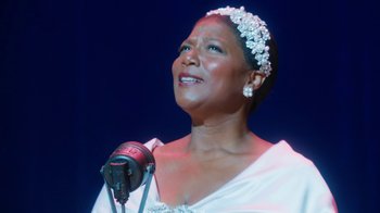 Movie still from “Bessie” (2015), directed by Dee Rees – A woman in a white dress singing on a stage; Close Up shot, Low angle