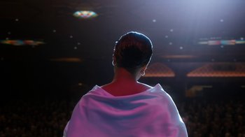 Movie still from “Bessie” (2015), directed by Dee Rees – A woman standing in front of a crowd wearing a white dress; Medium shot, Low angle