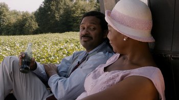 Movie still from “Bessie” (2015), directed by Dee Rees – A man and a woman sitting next to each other; Medium shot, Over the shoulder angle