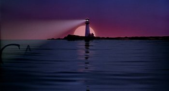 Movie still from “Best in Show” (2000), directed by Christopher Guest – A light house on a rock in the ocean at sunset; Extreme Wide shot, Low angle