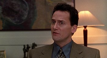 Movie still from “Best in Show” (2000), directed by Christopher Guest – A person wearing a suit and tie; Close Up shot, Low angle