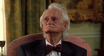 Movie still from “Best in Show” (2000), directed by Christopher Guest – An old man with a white beard wearing a suit and bow tie; Close Up shot, Low angle