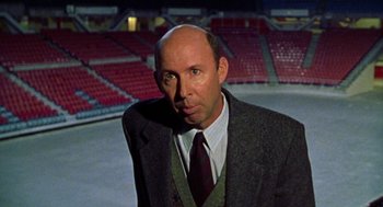 Movie still from “Best in Show” (2000), directed by Christopher Guest – A man in a suit and tie in an arena; Close Up shot, Low angle