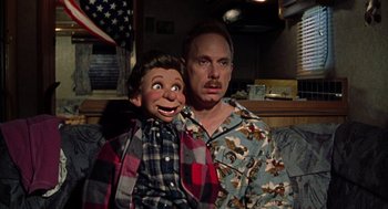Movie still from “Best in Show” (2000), directed by Christopher Guest – A man and a ventriloquist doll; Medium shot, Low angle