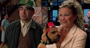 Movie still from “Best in Show” (2000), directed by Christopher Guest – A man and a woman holding a dog; Close Up shot, Over the shoulder angle