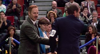 Movie still from “Best in Show” (2000), directed by Christopher Guest – Two men shaking hands in front of a crowd of people; Medium shot, Over the shoulder angle