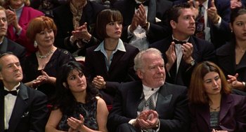 Movie still from “Best in Show” (2000), directed by Christopher Guest – A group of people sitting in a room clapping; Medium shot, Over the shoulder angle