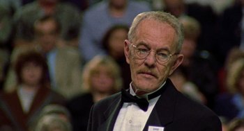 Movie still from “Best in Show” (2000), directed by Christopher Guest – An older man in a tuxedo with a bow tie; Close Up shot, Low angle