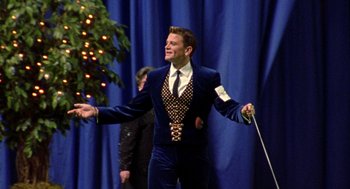 Movie still from “Best in Show” (2000), directed by Christopher Guest – A man in a blue velvet suit holding a cane; Medium shot, Low angle