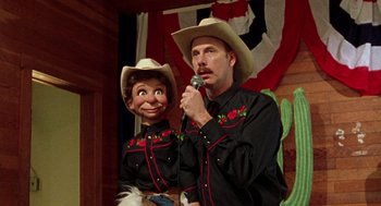 Movie still from “Best in Show” (2000), directed by Christopher Guest – A man and a woman dressed like a cowboy and a cowgirl; Close Up shot, Over the shoulder angle