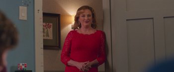 Movie still from “Better Watch Out” (2016), directed by Chris Peckover – A woman in a red dress standing in front of a mirror; Medium shot, Over the shoulder angle