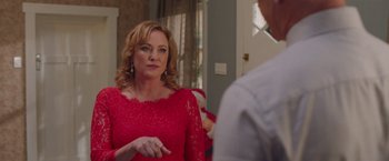 Movie still from “Better Watch Out” (2016), directed by Chris Peckover – A woman in a red dress talking to a man in front of a mirror; Close Up shot, Over the shoulder angle