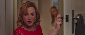 Movie still from “Better Watch Out” (2016), directed by Chris Peckover – A woman holding a cell phone in front of a mirror; Close Up shot, Over the shoulder angle