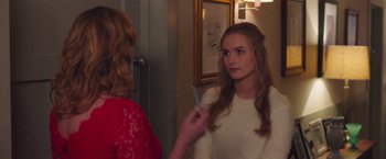 Movie still from “Better Watch Out” (2016), directed by Chris Peckover – A young woman holding a toothbrush in front of a mirror; Close Up shot, Over the shoulder angle