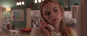 Movie still from “Better Watch Out” (2016), directed by Chris Peckover – A young woman talking on a cell phone while sitting down; Close Up shot, Over the shoulder angle