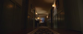 Movie still from “Better Watch Out” (2016), directed by Chris Peckover – A hallway with a rug and lamps in it; Extreme Wide shot, High angle