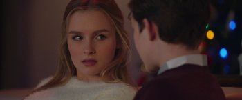 Movie still from “Better Watch Out” (2016), directed by Chris Peckover – A young woman looking at a young man in front of a mirror; Close Up shot, Over the shoulder angle