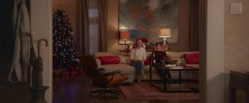 Movie still from “Better Watch Out” (2016), directed by Chris Peckover – Two people sitting on a couch in a living room; Wide shot, Low angle