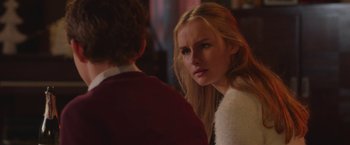 Movie still from “Better Watch Out” (2016), directed by Chris Peckover – A young woman looking at a young man in front of a mirror; Close Up shot, Over the shoulder angle