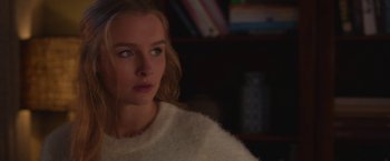 Movie still from “Better Watch Out” (2016), directed by Chris Peckover – A woman in a white sweater looking to her left; Close Up shot, Over the shoulder angle