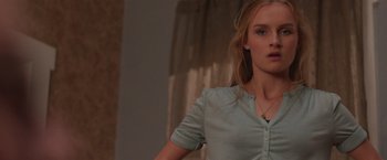 Movie still from “Better Watch Out” (2016), directed by Chris Peckover – A woman in a blue shirt is standing in a room; Close Up shot, Low angle