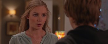 Movie still from “Better Watch Out” (2016), directed by Chris Peckover – A young woman talking to another young man; Close Up shot, Over the shoulder angle