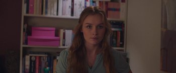 Movie still from “Better Watch Out” (2016), directed by Chris Peckover – A woman with long brown hair is looking at the camera; Close Up shot, Over the shoulder angle