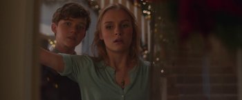 Movie still from “Better Watch Out” (2016), directed by Chris Peckover – A young woman standing next to a young man; Close Up shot, Low angle