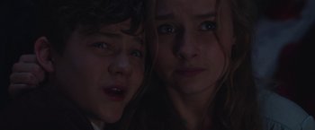 Movie still from “Better Watch Out” (2016), directed by Chris Peckover – Two young people are looking at the camera; Close Up shot, High angle