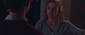 Movie still from “Better Watch Out” (2016), directed by Chris Peckover – A woman looking into a mirror while standing next to a wall; Close Up shot, Over the shoulder angle