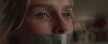Movie still from “Better Watch Out” (2016), directed by Chris Peckover – A woman with a duct tape over her mouth; Extreme Close Up shot, Low angle