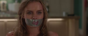 Movie still from “Better Watch Out” (2016), directed by Chris Peckover – A woman with duct tape over her mouth; Close Up shot, Low angle