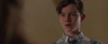Movie still from “Better Watch Out” (2016), directed by Chris Peckover – A young man is looking into the distance; Close Up shot, Over the shoulder angle