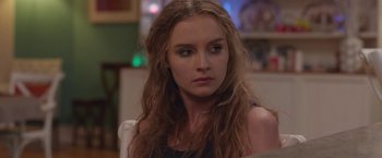 Movie still from “Better Watch Out” (2016), directed by Chris Peckover – A person sitting in a chair; Close Up shot, Over the shoulder angle