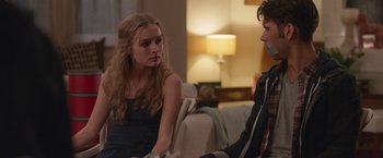 Movie still from “Better Watch Out” (2016), directed by Chris Peckover – A woman sitting next to a man in front of a couch; Medium shot, Over the shoulder angle