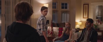 Movie still from “Better Watch Out” (2016), directed by Chris Peckover – A boy and a girl are sitting in a living room; Medium shot, Over the shoulder angle