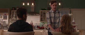 Movie still from “Better Watch Out” (2016), directed by Chris Peckover – A young man standing in front of two other young men; Medium shot, Over the shoulder angle