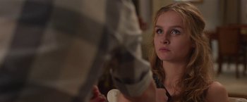 Movie still from “Better Watch Out” (2016), directed by Chris Peckover – A young woman is looking at the camera; Close Up shot, Over the shoulder angle