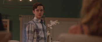 Movie still from “Better Watch Out” (2016), directed by Chris Peckover – A young man standing in front of a mirror; Medium shot, Over the shoulder angle