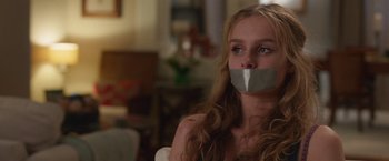 Movie still from “Better Watch Out” (2016), directed by Chris Peckover – A woman with duct tape over her mouth; Close Up shot, Over the shoulder angle