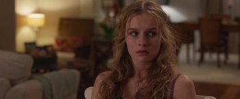 Movie still from “Better Watch Out” (2016), directed by Chris Peckover – A woman with long blonde curly hair stares into the camera; Close Up shot, Over the shoulder angle