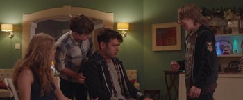 Movie still from “Better Watch Out” (2016), directed by Chris Peckover – Two young men in a living room with a couch; Medium shot, Over the shoulder angle