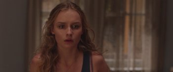 Movie still from “Better Watch Out” (2016), directed by Chris Peckover – A person with long curly hair; Close Up shot, Over the shoulder angle