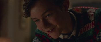 Movie still from “Better Watch Out” (2016), directed by Chris Peckover – A person smiling at the camera; Close Up shot, Over the shoulder angle