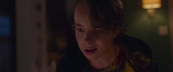 Movie still from “Better Watch Out” (2016), directed by Chris Peckover – A young boy is looking into the dark; Close Up shot, Over the shoulder angle