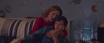 Movie still from “Better Watch Out” (2016), directed by Chris Peckover – A woman and a boy are hugging in a room; Medium shot, High angle